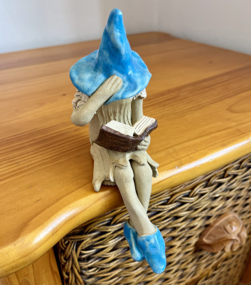 Over the edge holding a book